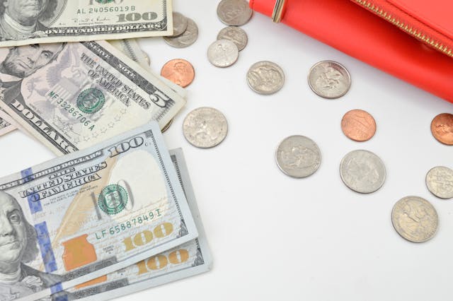 american-hundred-dollar-bills-and-coins-on-table